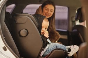 Young mother and child in car. Baby seat on chair. Safety driving concept. AA Ireland