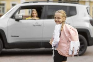 side-view-smiley-girl-going-school