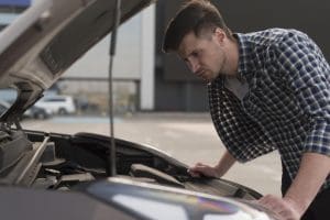 Man checking his car before long weekend