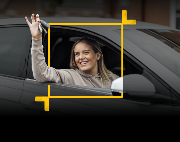 Person sitting in a car waving keys